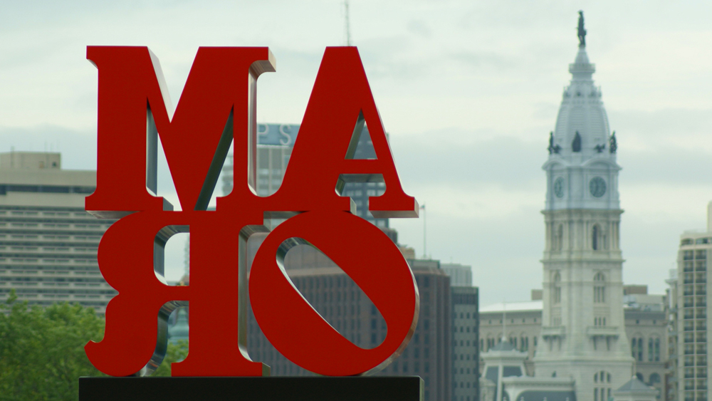 Looking at Robert Indiana's "AMOR" from behind with City Hall in the background