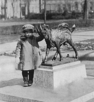 A young girl poses with the Billy sculpture from 1919