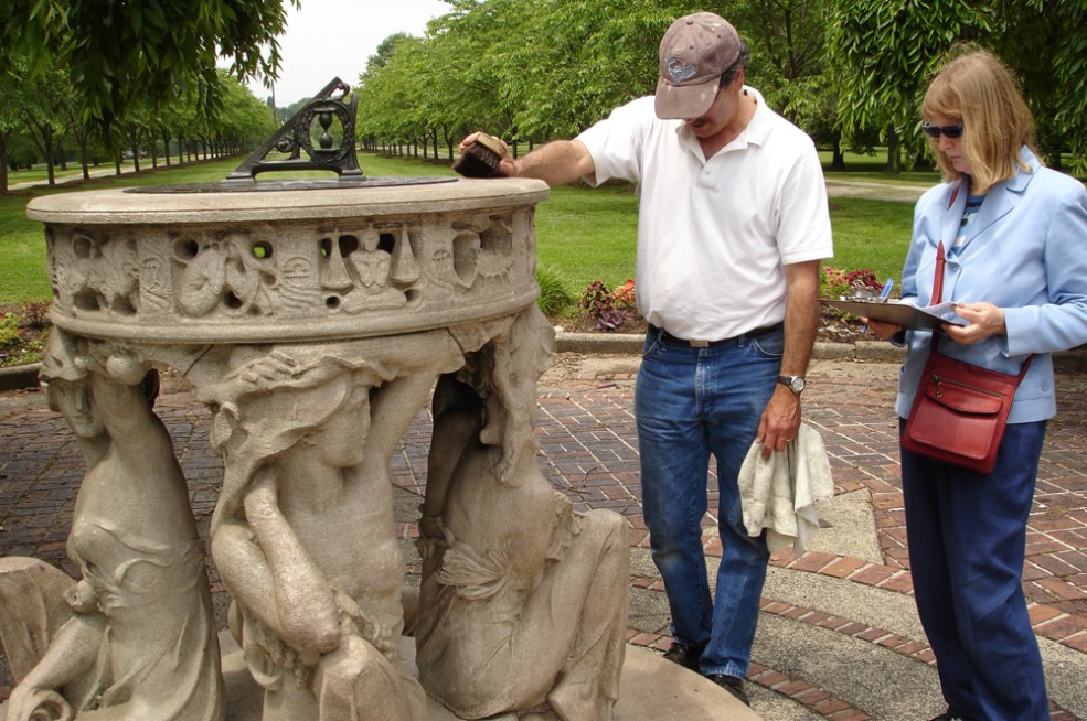 The conservation team inspects Alexander Stirling Calder’s <em>Sundial</em> (1903). Photo © Association for Public Art.