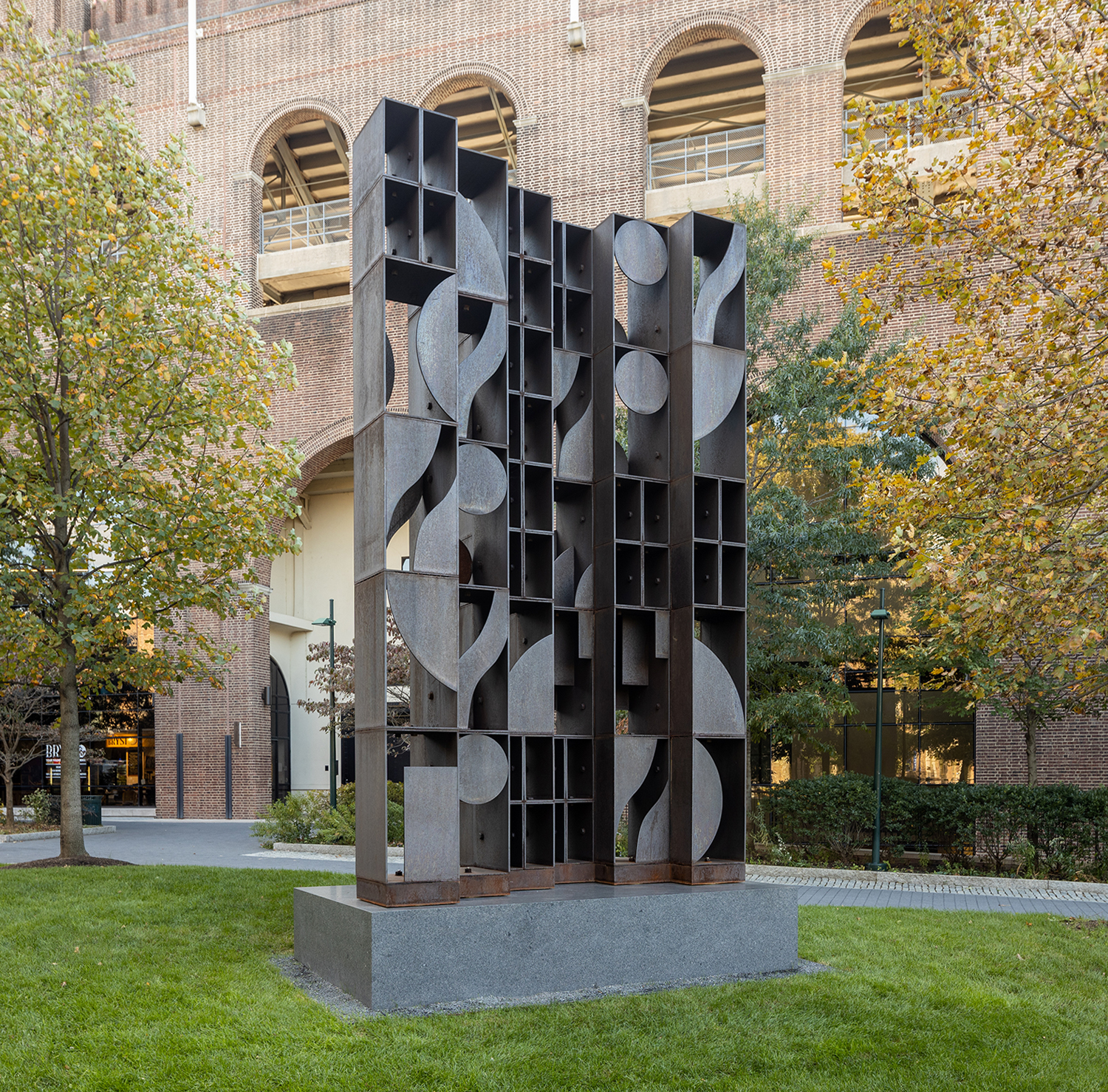 Tall geometric cor-ten steel sculpture by Louise Nevelson on University of Pennsylvania campus