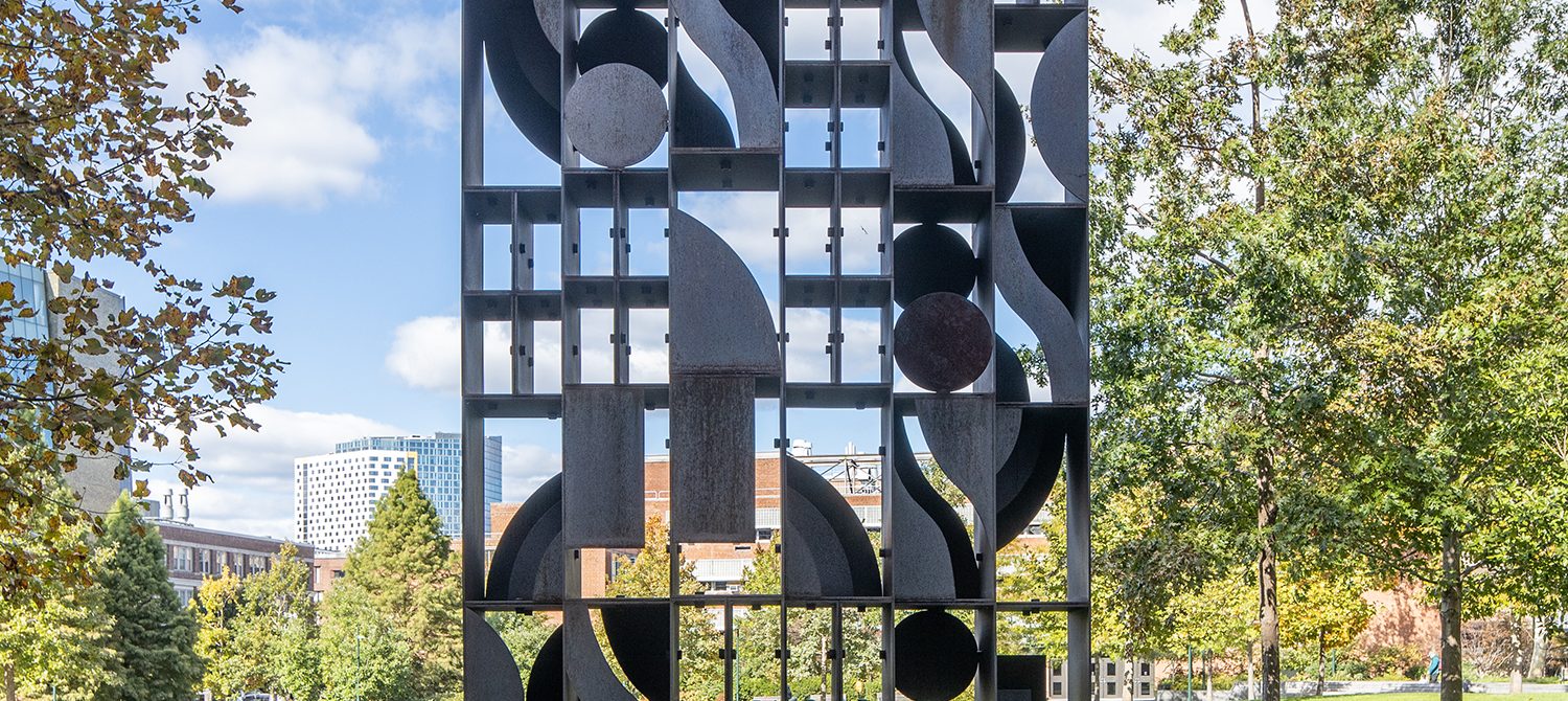 Tall geometric cor-ten steel sculpture by Louise Nevelson on University of Pennsylvania campus