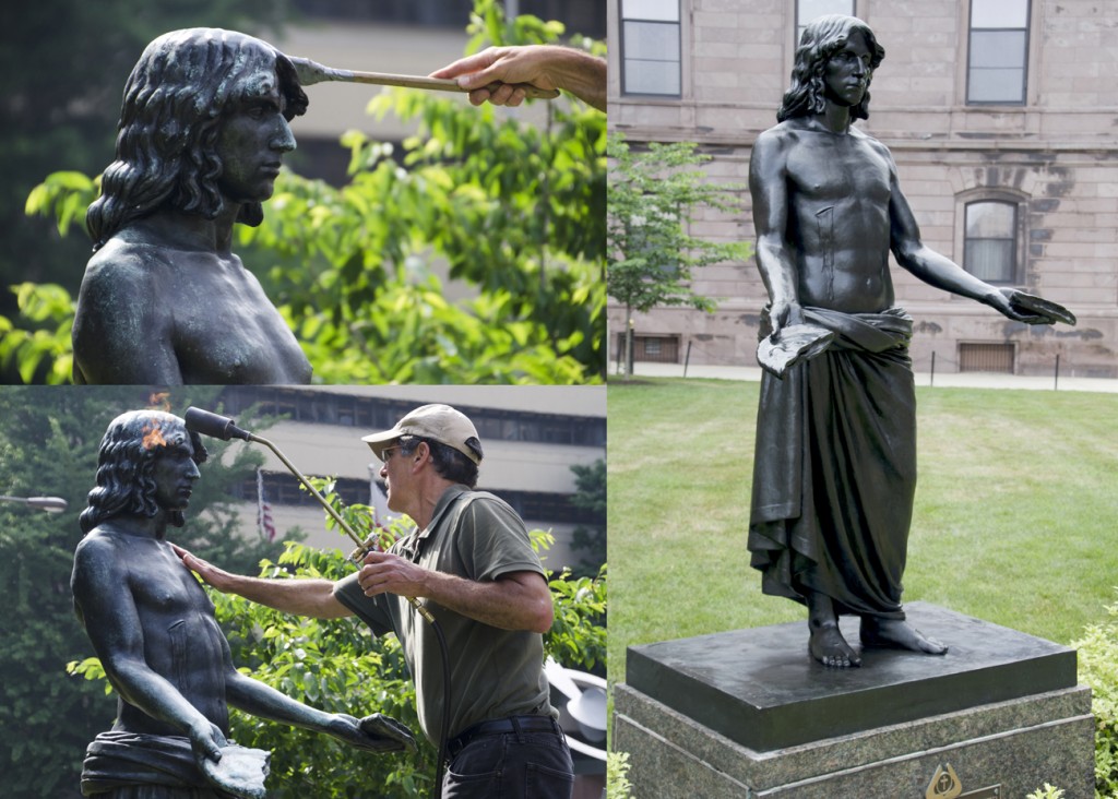 A conservator works on Jesus Breaking Bread by Walter Erlebacher