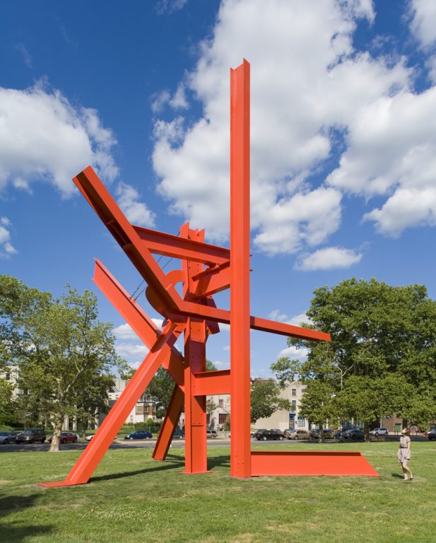 A woman walks by Mark di Suvero's monumental Iroquois sculpture