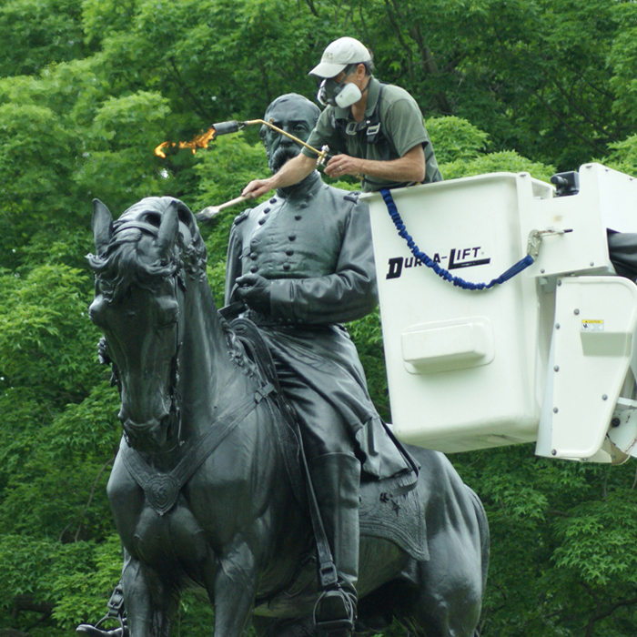 A conservator applies a protective wax coating on Alexander Milne Calder's <em>Major General George Gordon Meade</em> (1887). Photo © Caitlin Martin for the Association for Public Art.