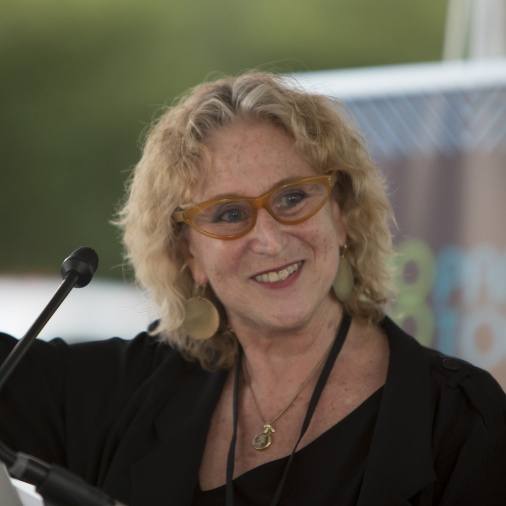 Photo of Executive Director Penny Balkin Bach speaking at OPEN AIR celebration