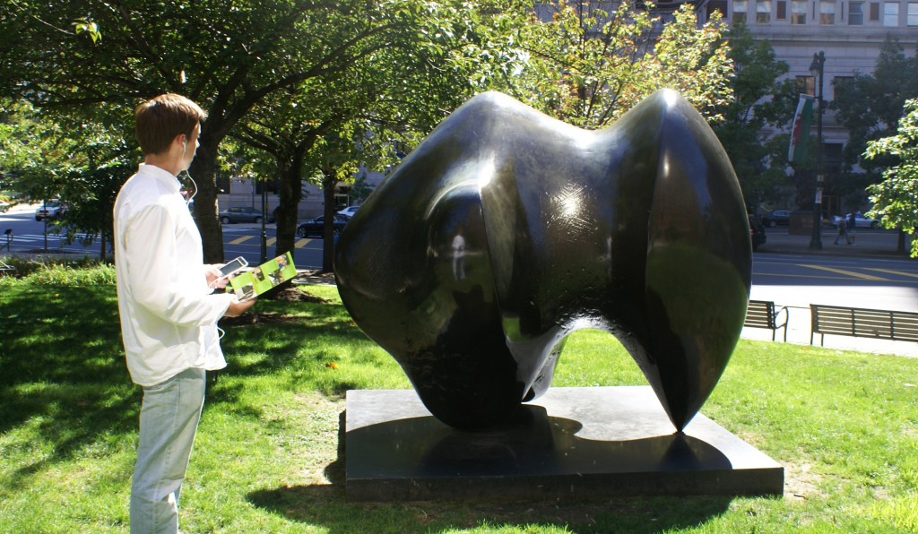 Participant uses our Museum Without Walls™: AUDIO iPod App to learn more about Henry Moore’s "Three Way Piece Number 1: Points." 