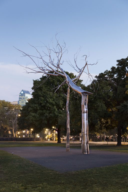 Roxy Paine's Symbiosis sculpture at twilight