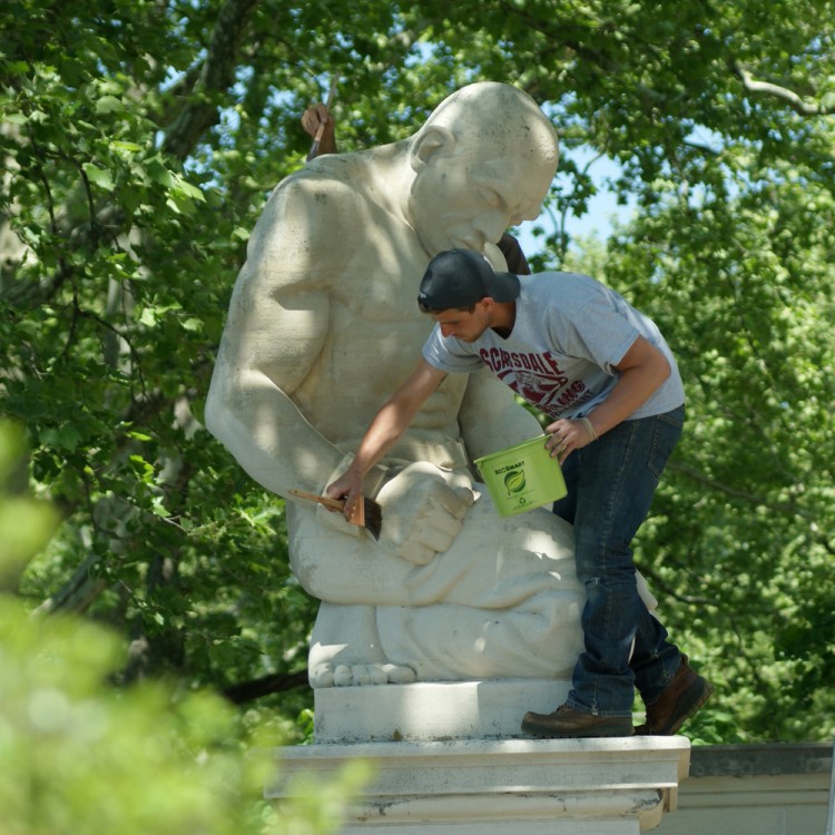 Conservators apply a special protective surface coating on Helene Sardeau's <em>The Slave</em> (1940). Photo © Caitlin Martin  for Association for Public Art.