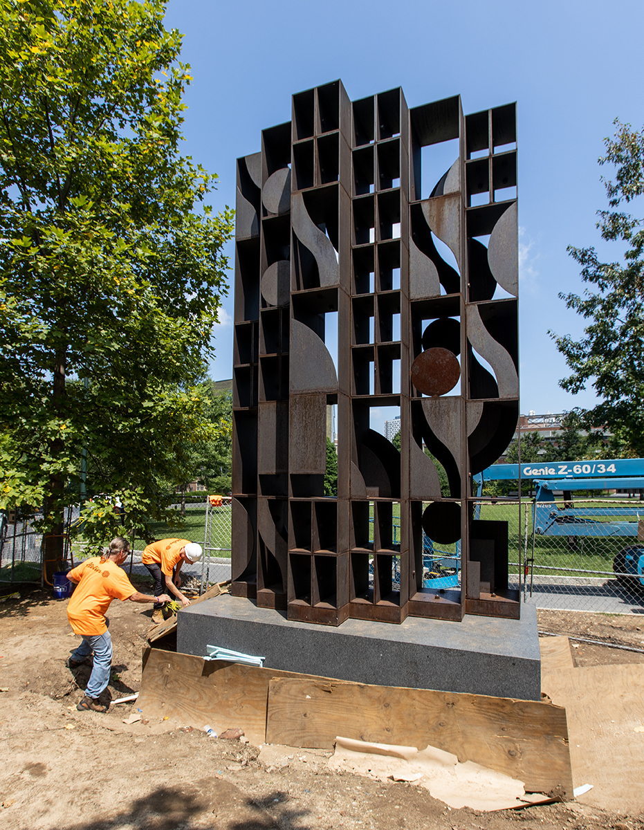 Installing Louise Nevelson bronze geometric sculpture, Atmosphere and Environment