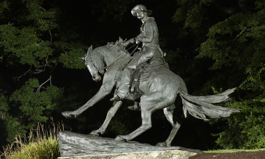 Night time view of "Cowboy" by Frederic Remington