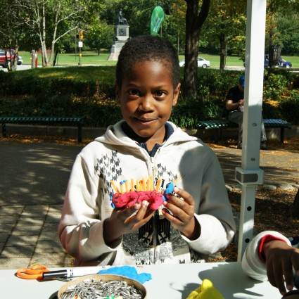 Young boy shows off his sculpture creation at Sculpture Saturdays on Kelly Drive