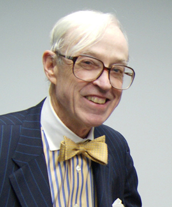 A portrait of Mr. Gregory Harvey smiling and wearing a yellow bowtie