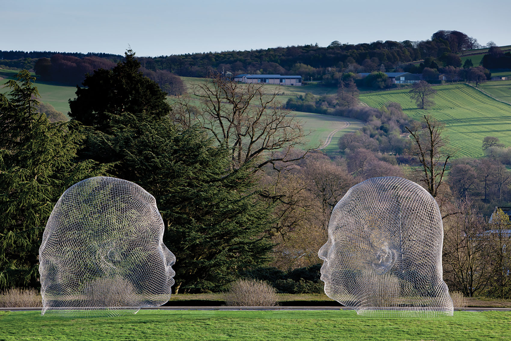 Jaume Plensa sculpture at Yorkshire Sculpture Park - two large heads facing each other 