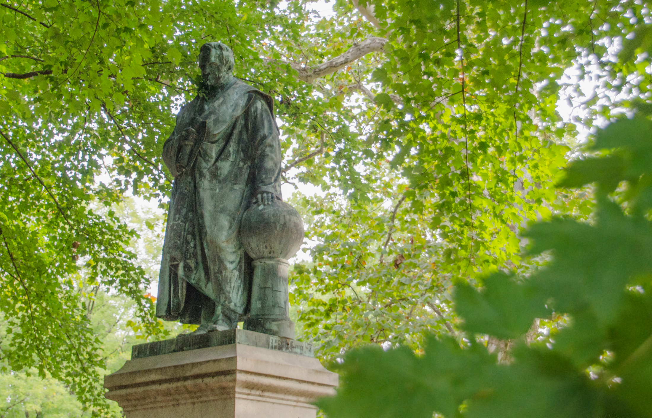Statue of Alexander von Humboldt surrounded by green leaves in Philadelphia's Fairmount Park