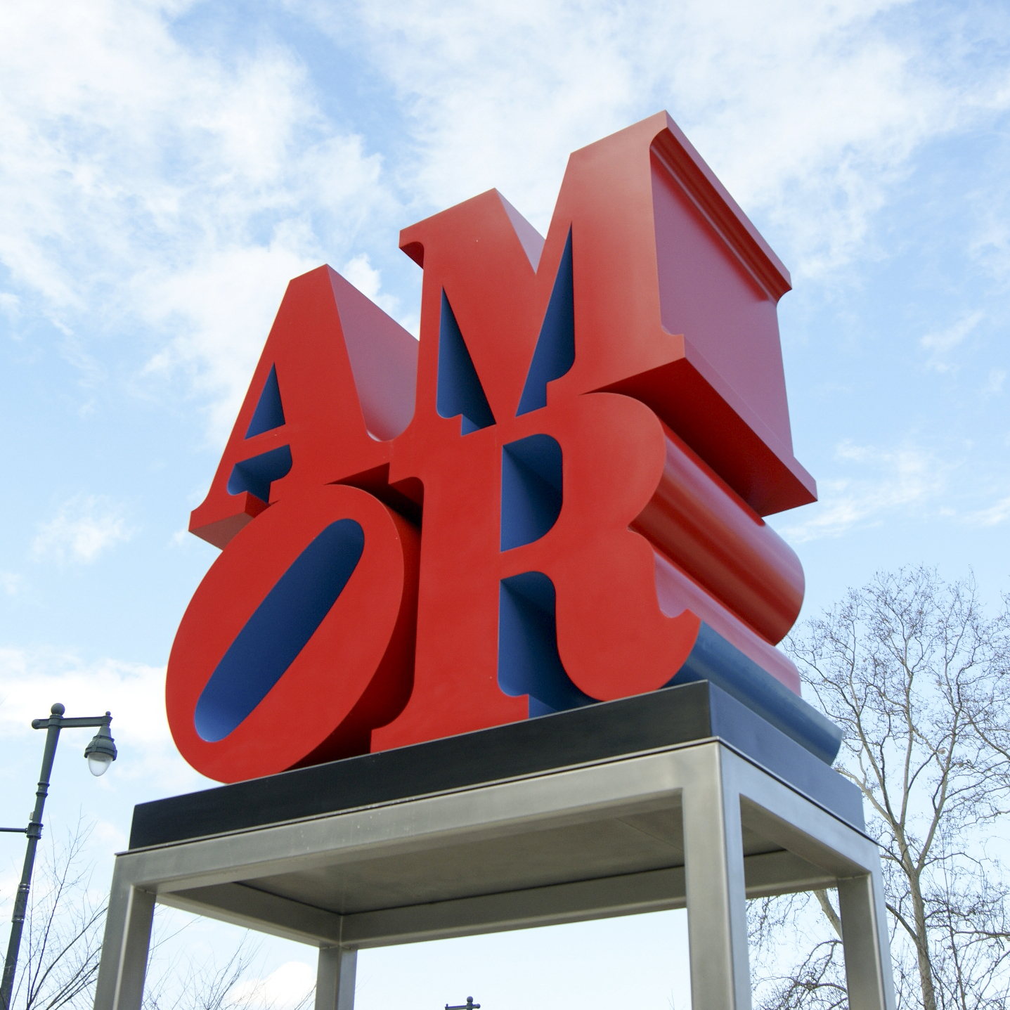 AMOR red sculpture against blue sky