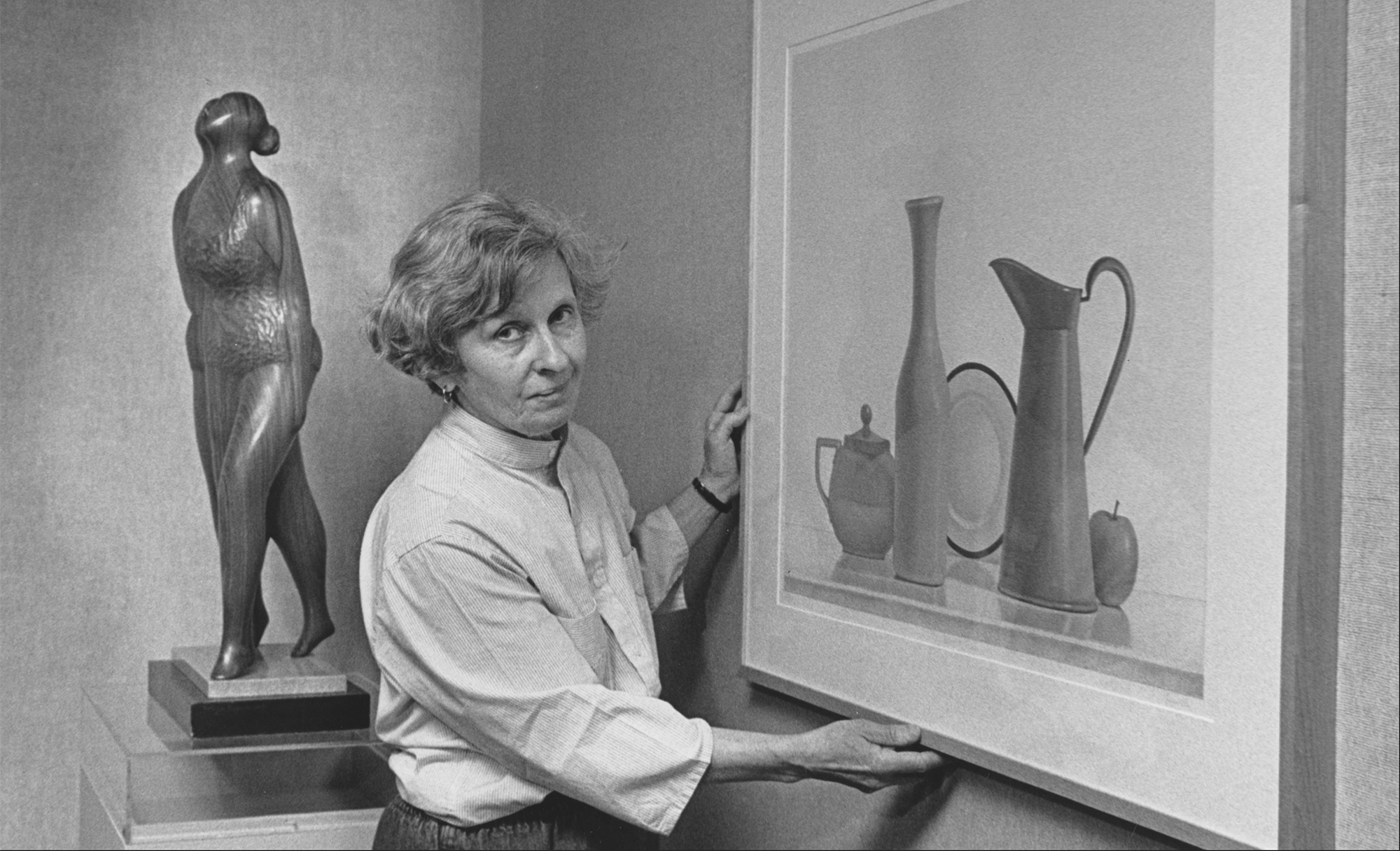 Keyser hangs her twin sister's painting for their 1988 exhibit at Tyler School of Art. Keyser's wood sculpture is seen in the background.