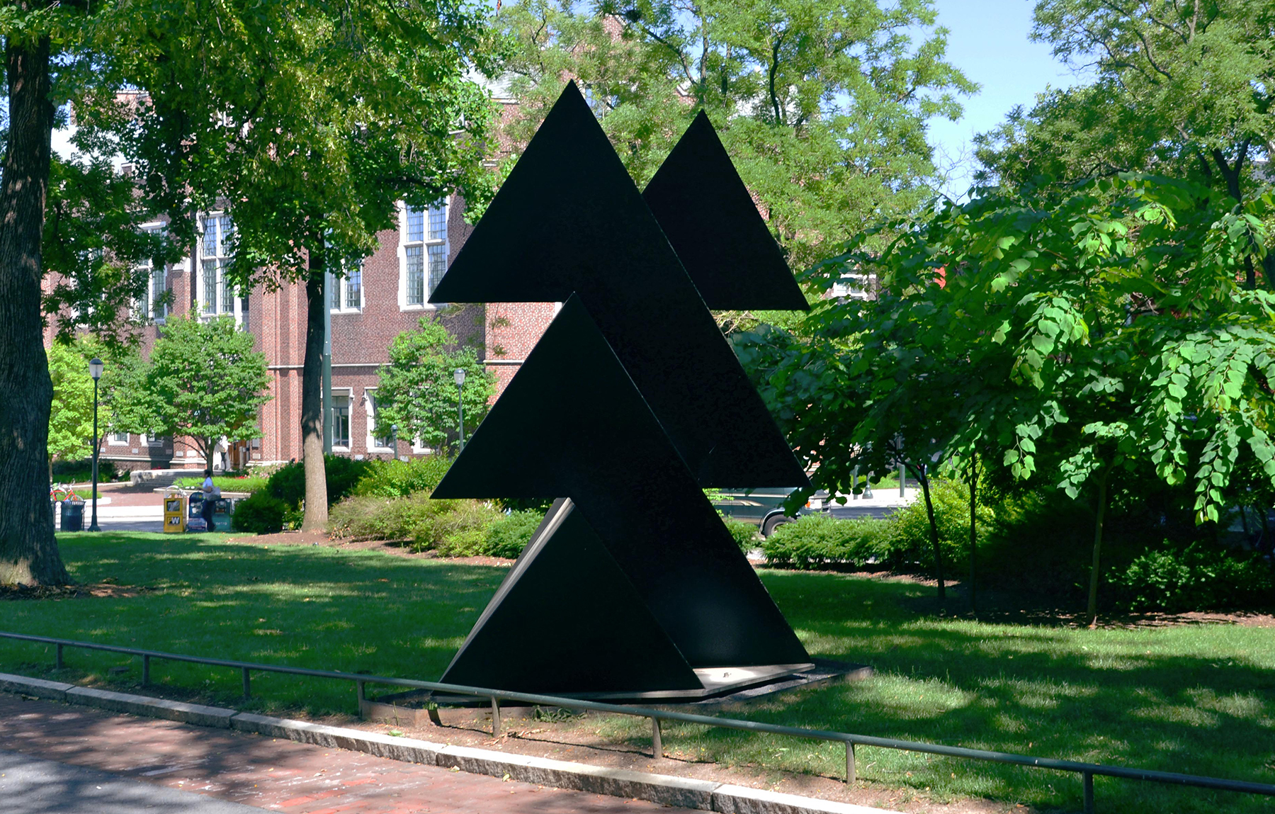 Black painted steel geometric sculpture, angular forms, on University of Pennsylvania campus in grass