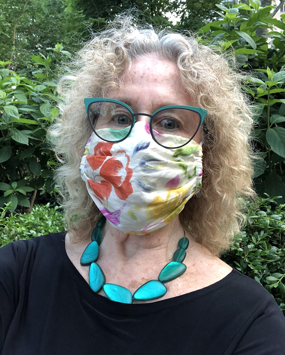 Executive Director of the Association for Public Art, outside with a floral mask on