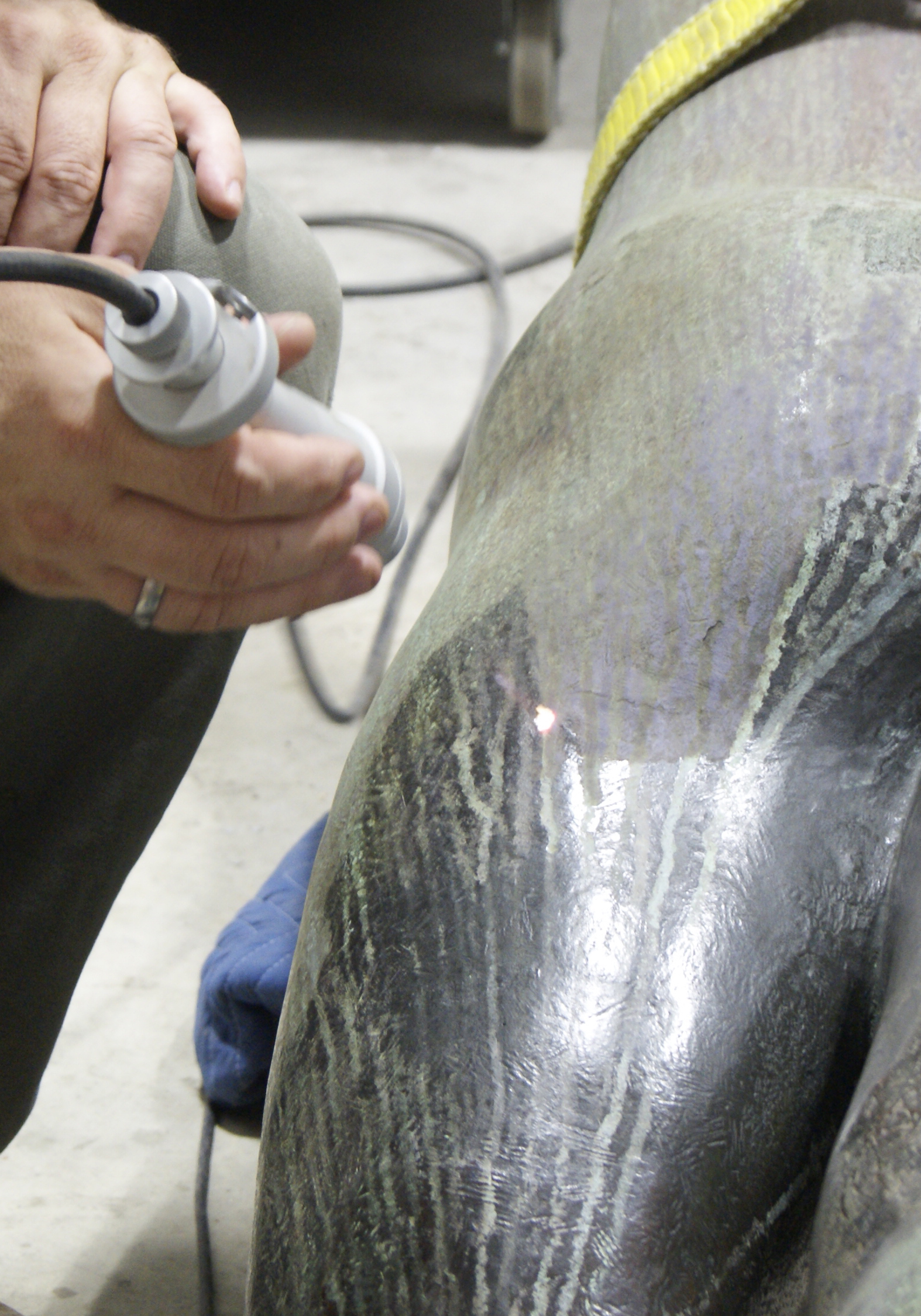 Conservator Adam Jenkins uses laser technology to carefully remove the corrosion on the bronze