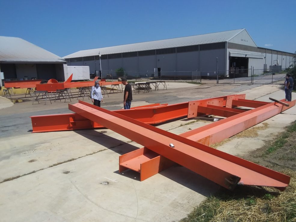 <em>Iroquois</em> I-beams at Color Works industrial paint facility in Delaware, where they were stripped and repainted in 2022. Photo by Laura Griffith for Association for Public Art.