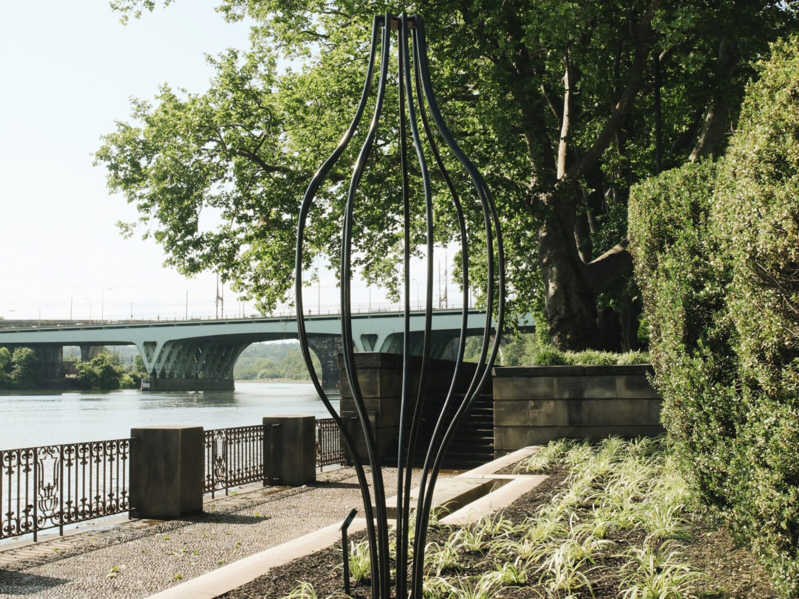 One of ten large-scale open metal vessel sculptures by Maren Hassinger, installed at the Ellen Phillips Samuel Memorial in Philadelphia, along Kelly Drive and the Schuylkill River. Inspired by ancient iconic vessel archetypes, the abstract sculptures suggest three-dimensional line drawings that vividly connect art with nature.