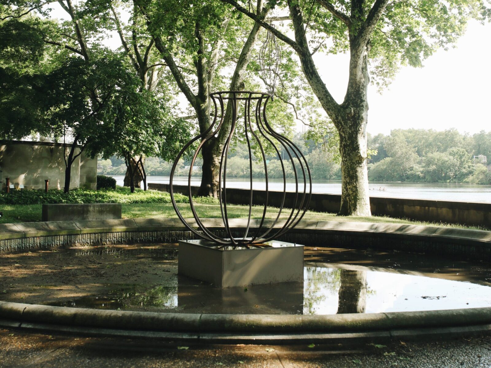 One of ten large-scale open metal vessel sculptures by Maren Hassinger, installed at the Ellen Phillips Samuel Memorial in Philadelphia, along Kelly Drive and the Schuylkill River. Inspired by ancient iconic vessel archetypes, the abstract sculptures suggest three-dimensional line drawings that vividly connect art with nature.