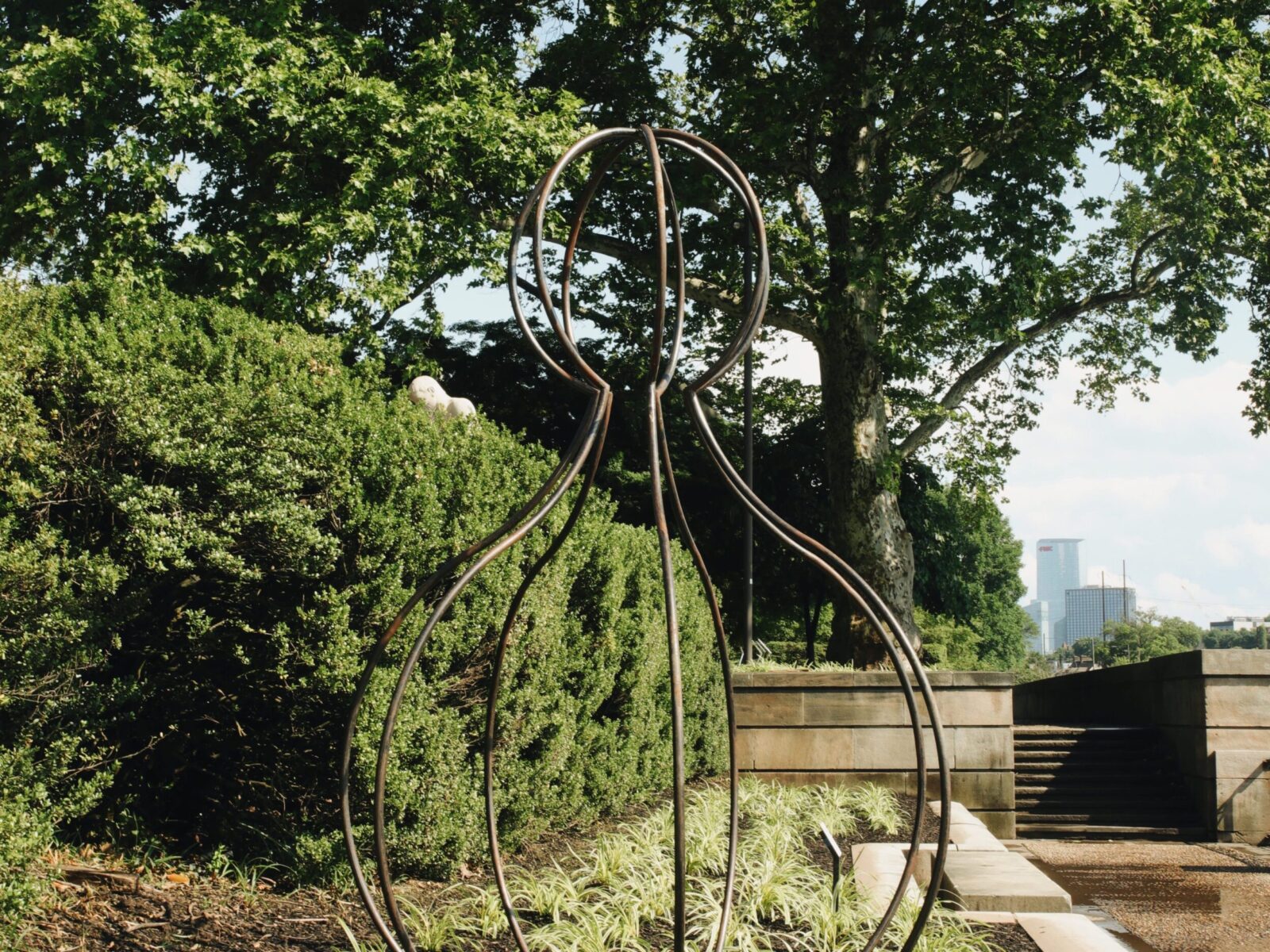 One of ten large-scale open metal vessel sculptures by Maren Hassinger, installed at the Ellen Phillips Samuel Memorial in Philadelphia, along Kelly Drive and the Schuylkill River. Inspired by ancient iconic vessel archetypes, the abstract sculptures suggest three-dimensional line drawings that vividly connect art with nature.